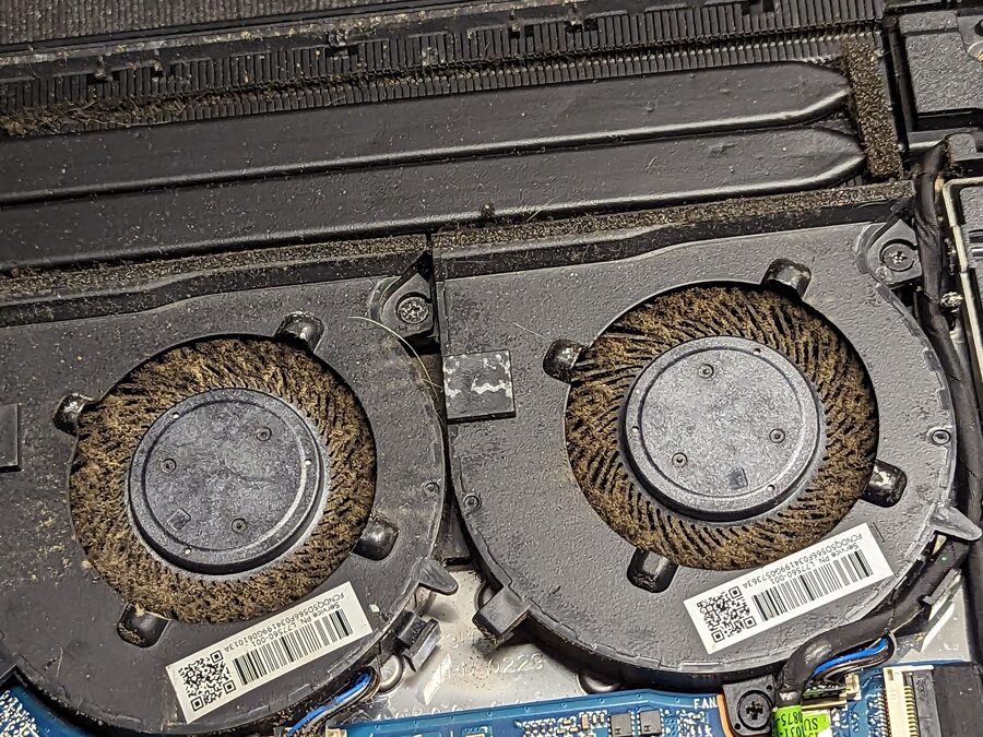 Laptop cooling fans clogged with dust before cleaning