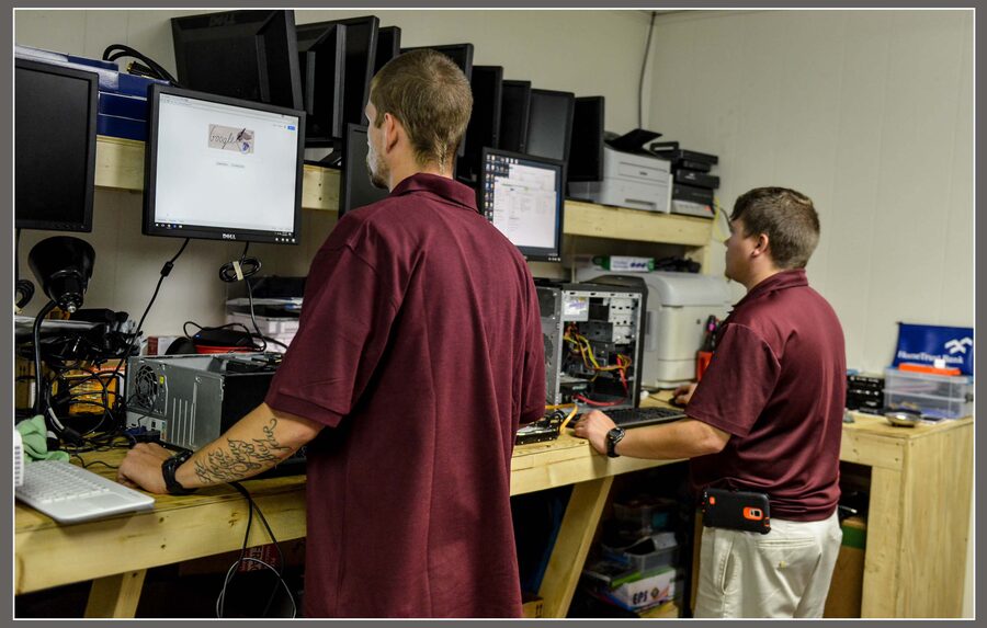 Two Discount Computer technicians working at the repair bench
